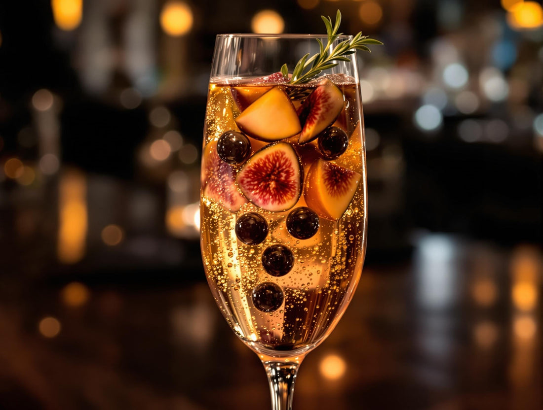 Fig Pearl Sunset Fizz cocktail with muddled fresh figs creating purple-pink hue and small Sticky Balsamic Premium Fig Pearls sinking through the liquid