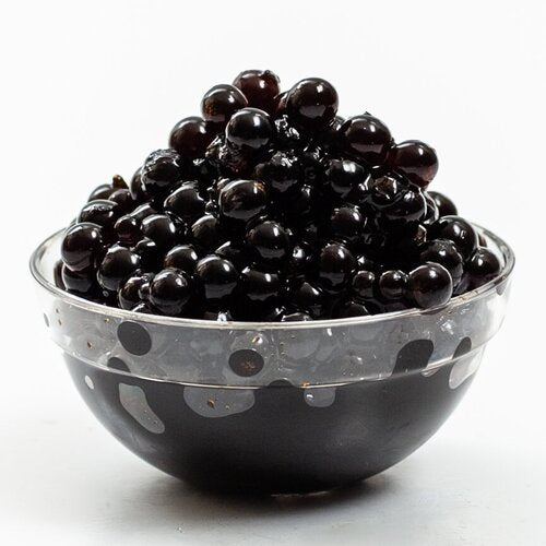 Sticky Balsamic Pearls - Original pearls in a clear plastic container showing the form and glistening appearance of the pearls