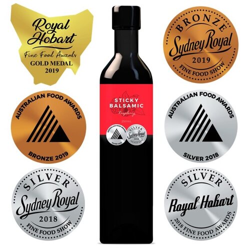 Sticky Balsamic Premium Raspberry 250ml bottle surrounded by medals showing its quality.