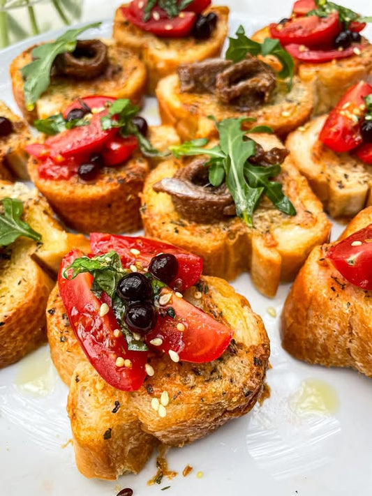 Garlic Parmesan Toasts with Anchovies, Rocket and Tomato Basil Toppings and sticky Balsamic Pearls