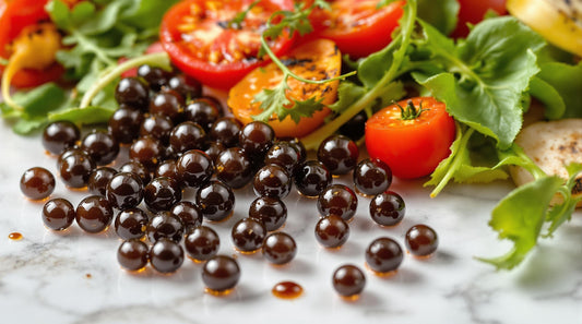 Balsamic Caviar is Vegetarian. Tomatoes and arugula on a marble bench with vegetarian balsamic caviar.