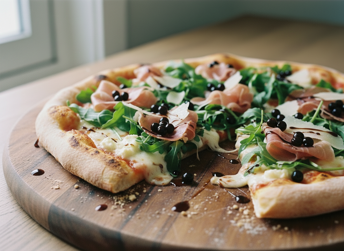 prosciutto, rocket and goat’s cheese pizza on a board, finished with glossy dark Original Balsamic Pearls