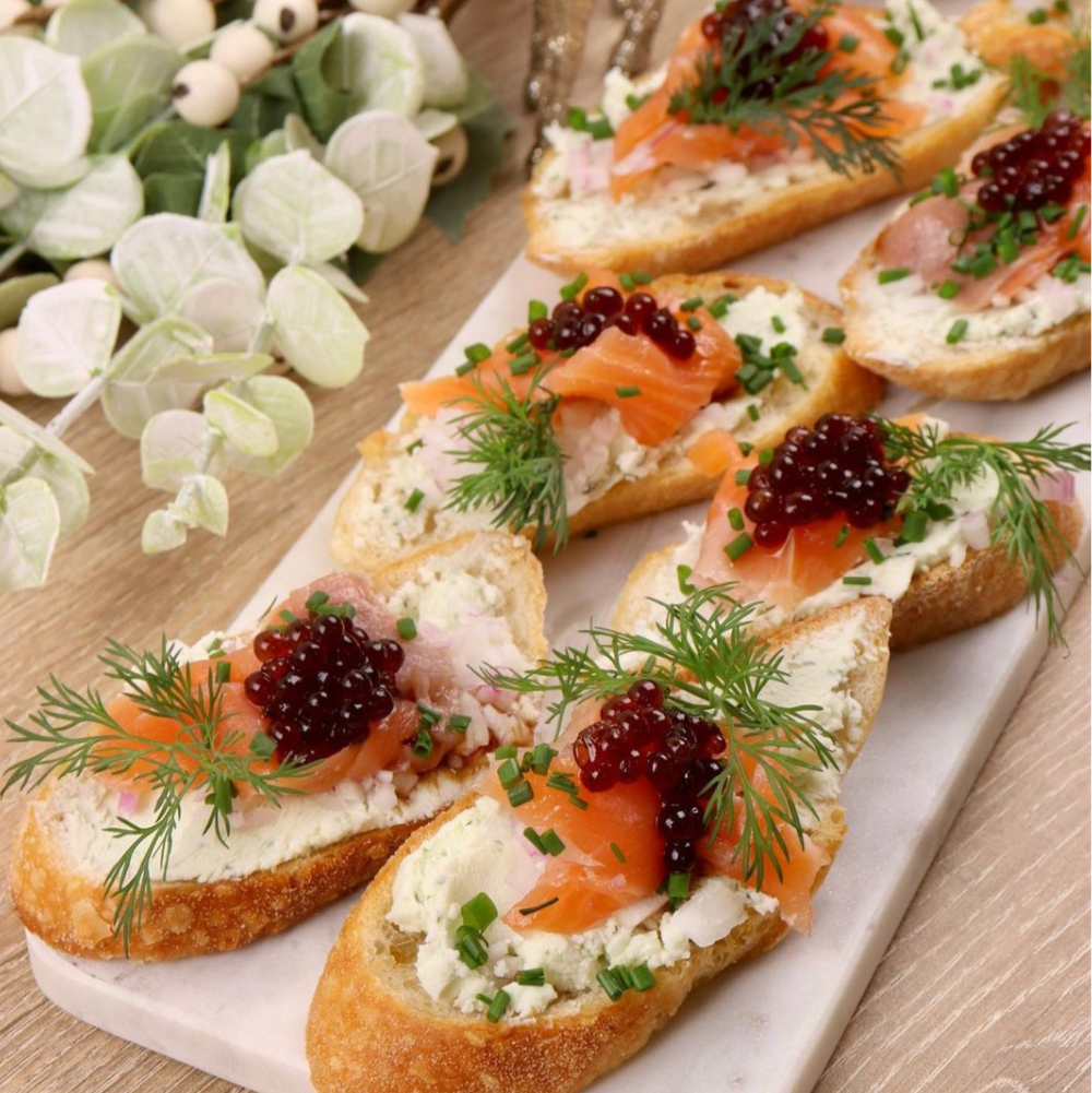 Canapes with salmon and sticky balsamic pearls.