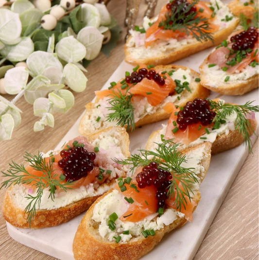 Canapes with salmon and sticky balsamic pearls.