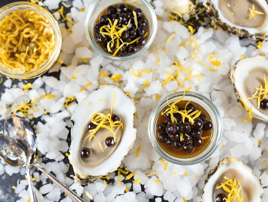 Fresh oysters with dark Sticky Balsamic Lemon Pearls mignonette and lemon zest garnish on crushed ice