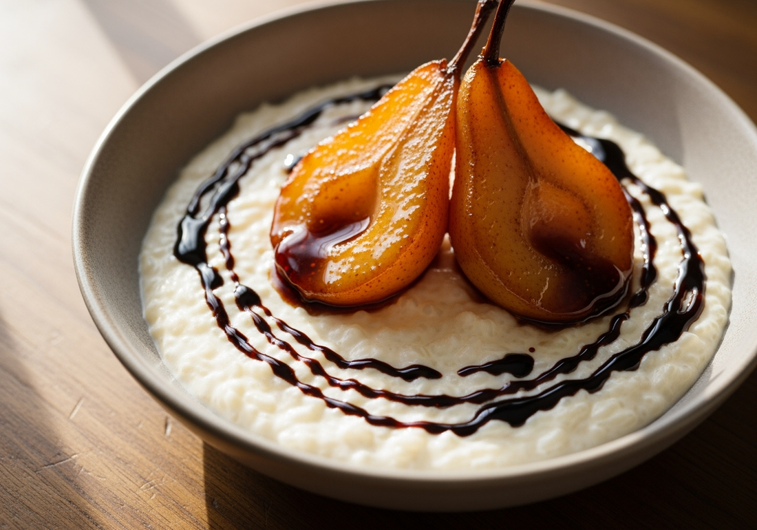 Creamy rice pudding topped with halved balsamic poached pears glistening with Sticky Balsamic Premium Fig glaze, elegantly arranged in a grey ceramic bowl