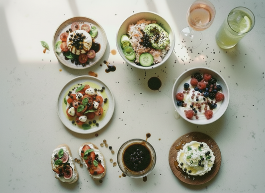 Aesthetic TikTok‑worthy food spread featuring salads, yogurt bowls, crostini, salmon bowls, fresh fruit, and gourmet toppings with balsamic pearls for an easy, elevated look.