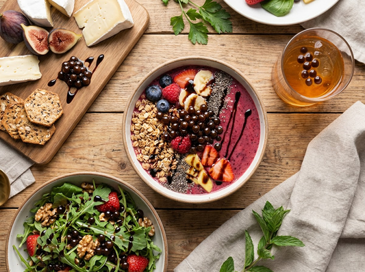 An ultra-realistic, professional food photography flat lay featuring the versatility of Sticky Balsamic Pearls.
