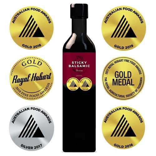 Sticky balsamic vinegar bottle with award medal stickers around the label.